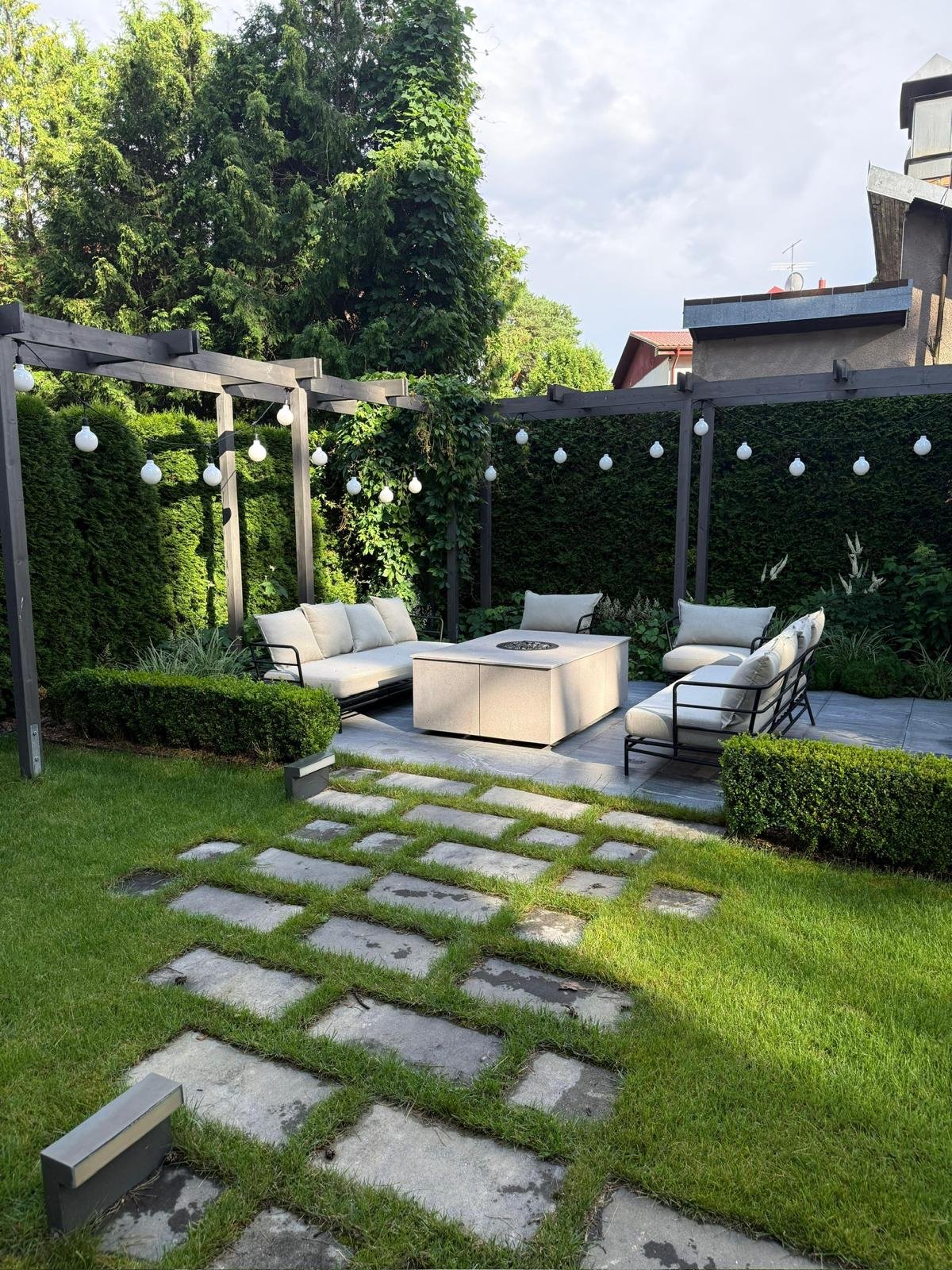 Pergola with festoon lights and stepping stone pathway